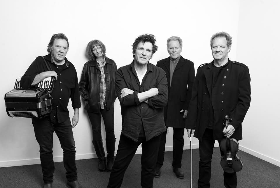 Legendary New Zealand band members in a promotional photo, showcasing their musical talent and vibrant personalities. Famous for their contributions to NZ music scene, performing in Paekākāriki.